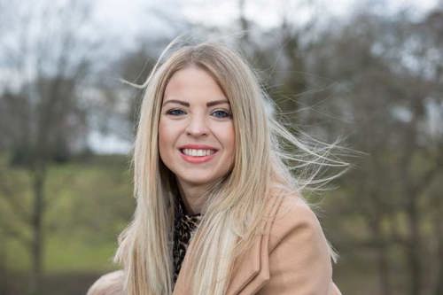 Zoe Lee, who has, palindromic rheumatism, stood outside looking at the camera smiling.