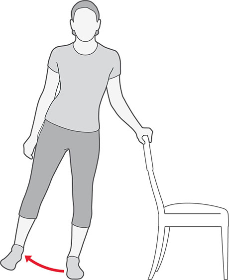 An illustration of someone standing and holding onto a chair, lifting their leg sideways.