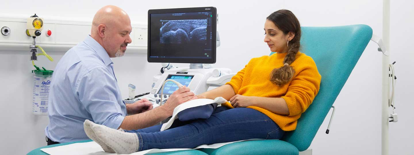 Doctor scanning a patient's hand.