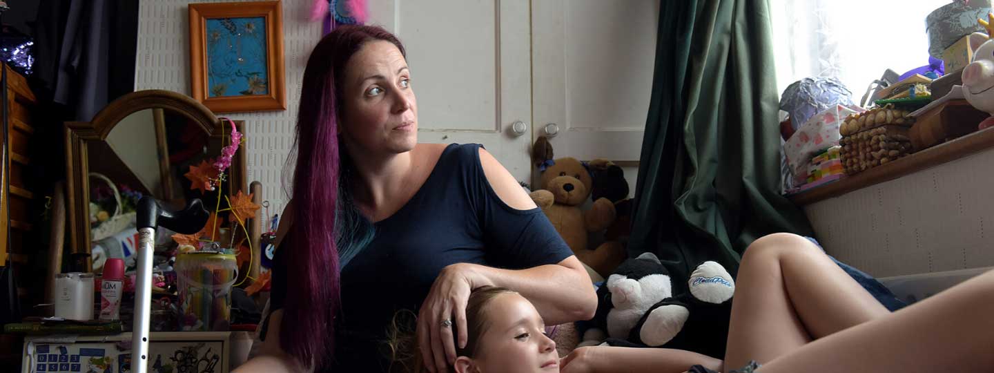 Catherine with her daughter resting in bed.
