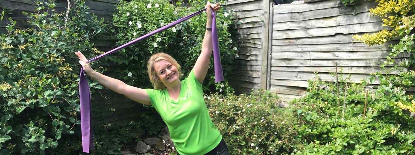Alison Bailey doing exercises in her garden.