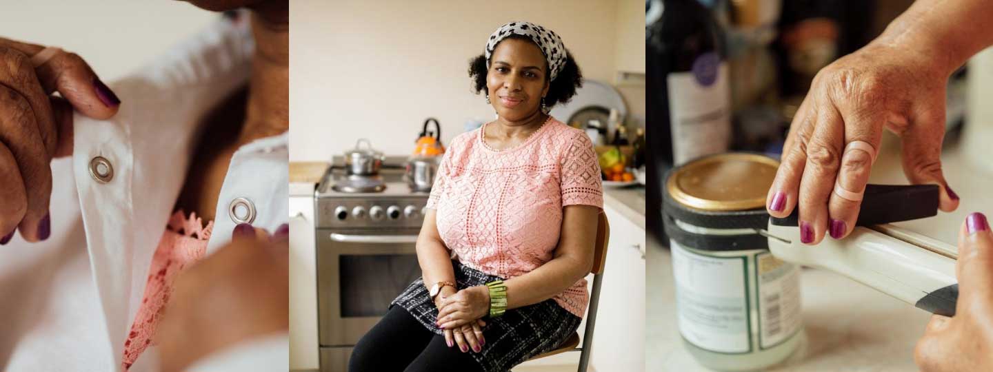 Lady doing up her blouse, sitting on a chair and opening a tin with a tin opener.