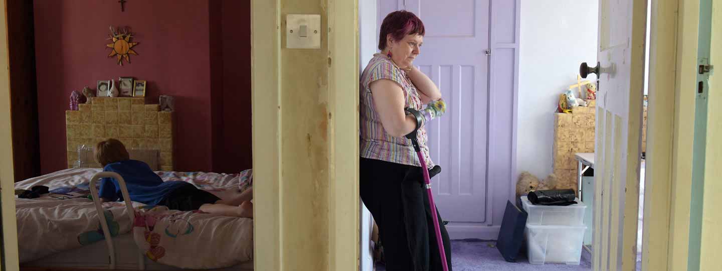 Gillian in the bedroom leaning against a wall.