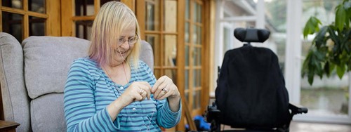 A lady doing knitting.