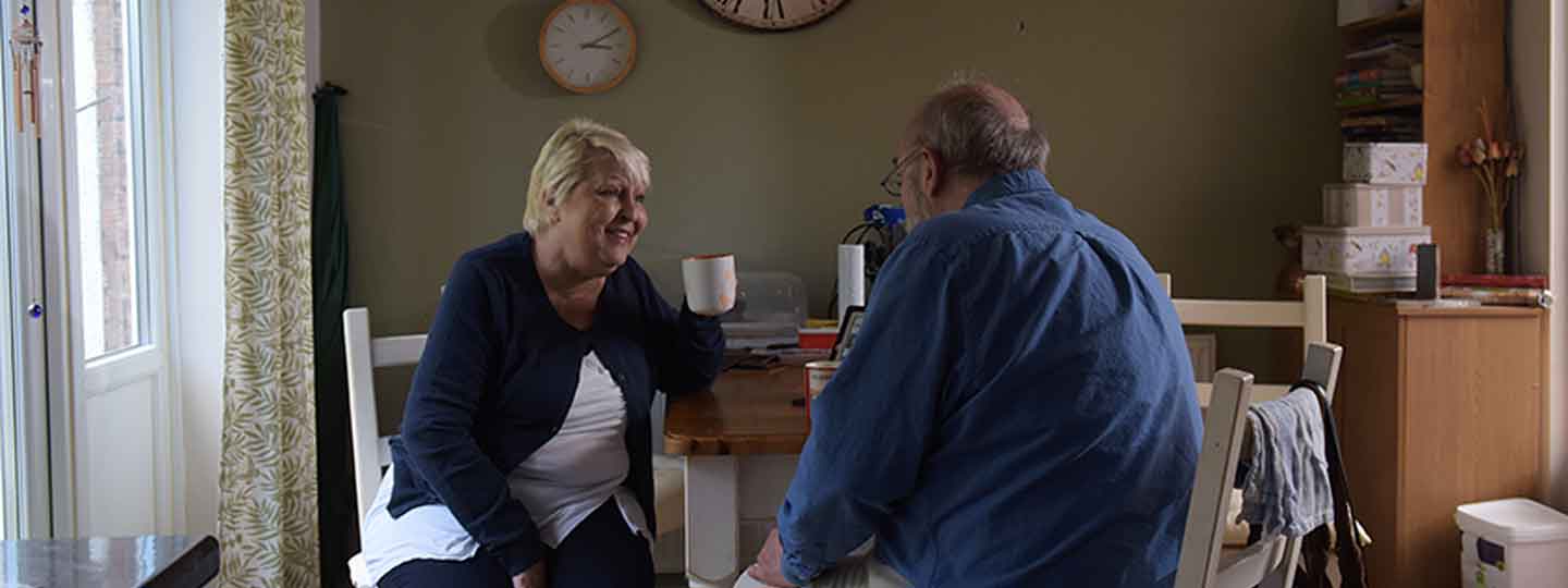 Collette in the kitchen with her husband.