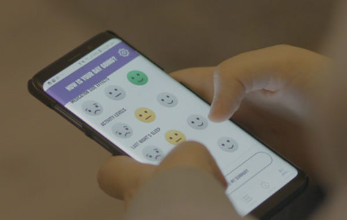 Person holding phone displaying Arthritis Tracker app