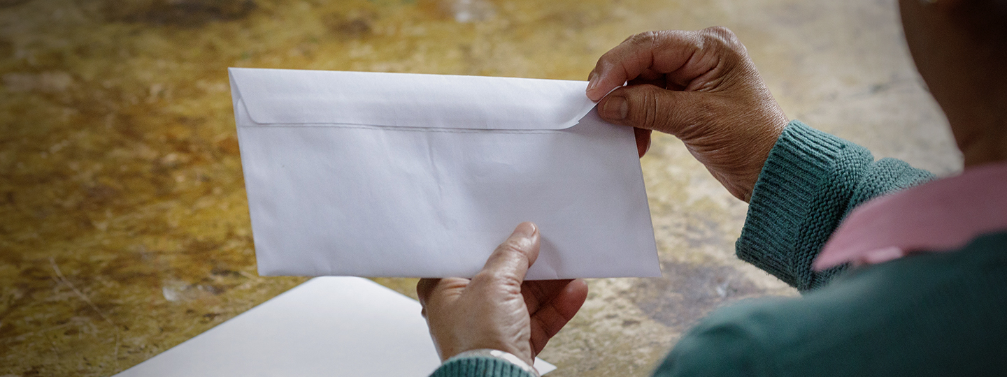 A person opening a bill