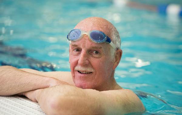 Man in swimming pool wearing goggles