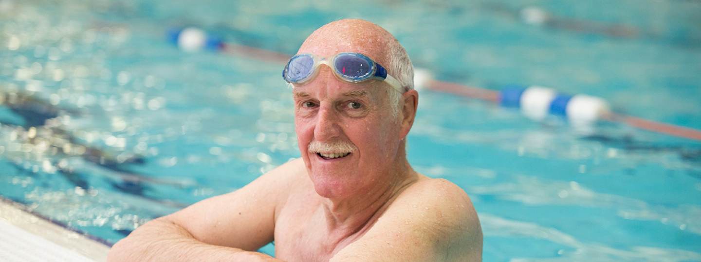 Man wearing goggles in swimming pool 