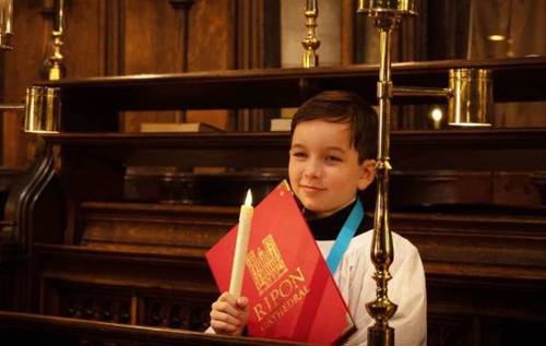 William smiling holding a calendar in Ripon Catherdral