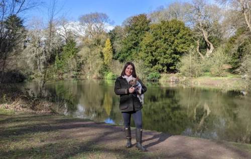 Young woman and her dog in woodlands