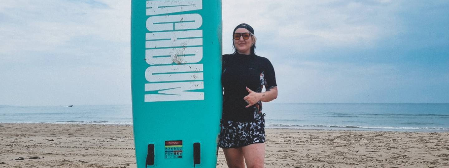 Emma holding a paddleboard 