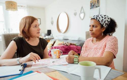 Two people talking at table