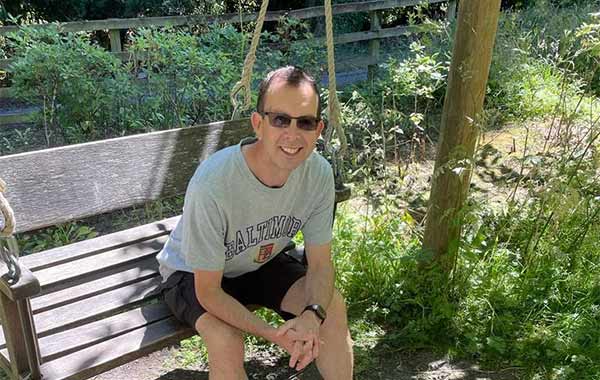 Jon Smiling On A Bench In The Park