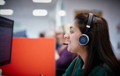 Smiling Helpline Advisor wearing headset