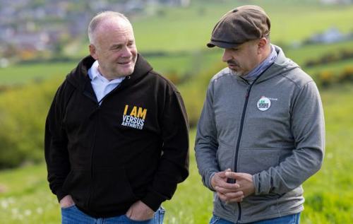 Two men talking while on a walk