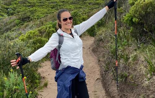 Smiling Pippa holding walking poles