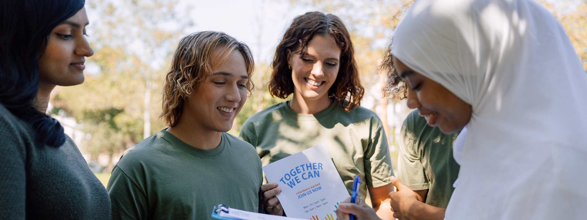 A group of positive young people get involved by sharing leaflets and signing forms to campaign in support of arthritis campaigns