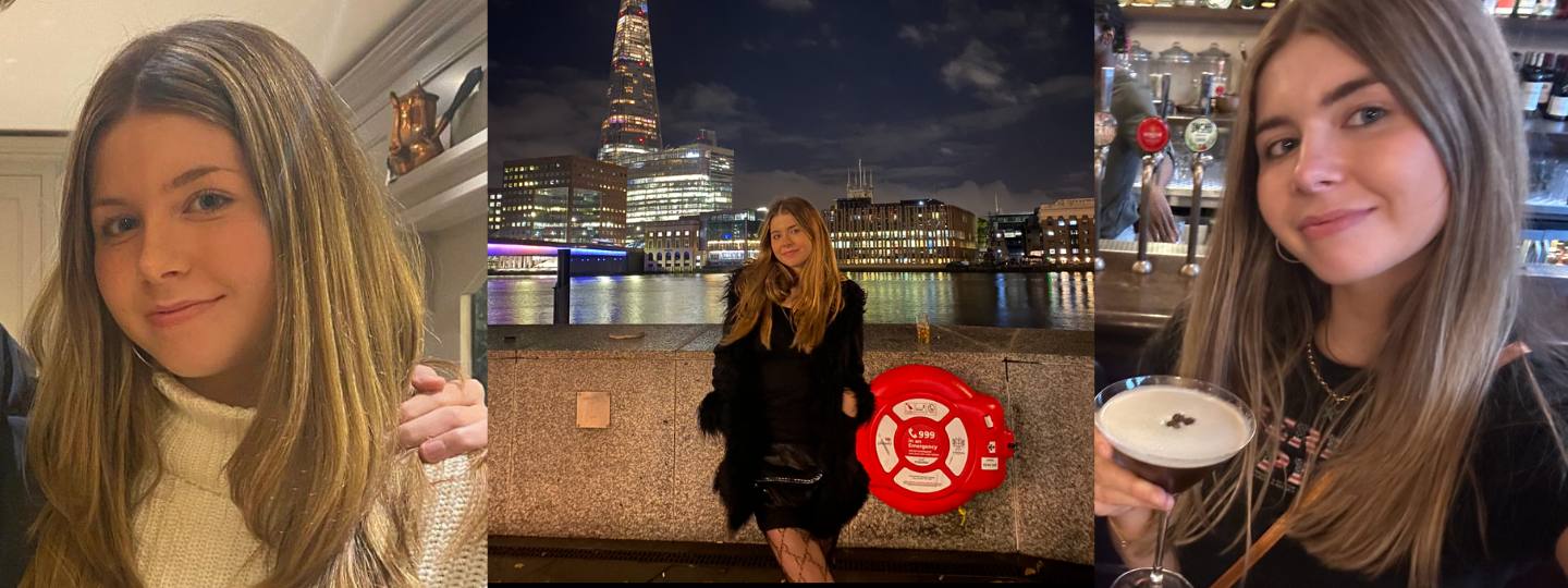 Smiling Daisy standing in front of the Thames, London. 