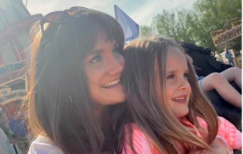 Zoe and Mali smiling at the funfair in the sun