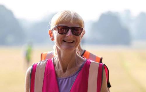 Smiling Phyllida wearing pink high vis jacket and sunglesses