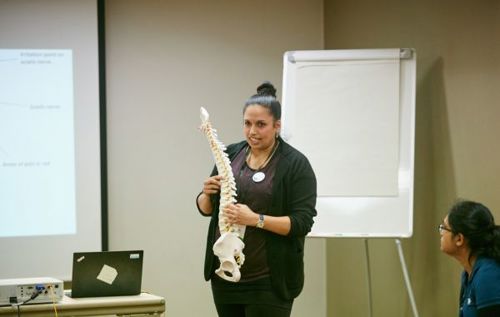 Woman holding spine prop