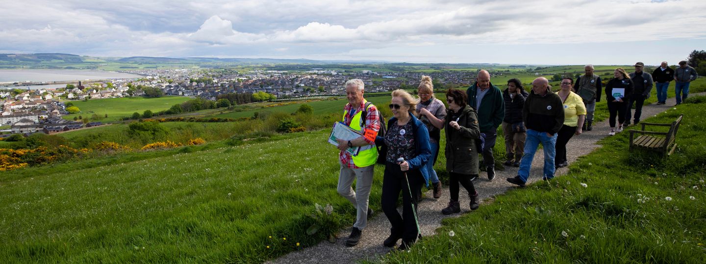 People walking in a field, showing the importance of exercise for Arthritis 