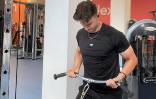 Issac using machine at the gym